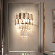 Modern tiered smoke gray crystal wall sconce with clear and smoky glass rods on a sleek metallic frame for living room