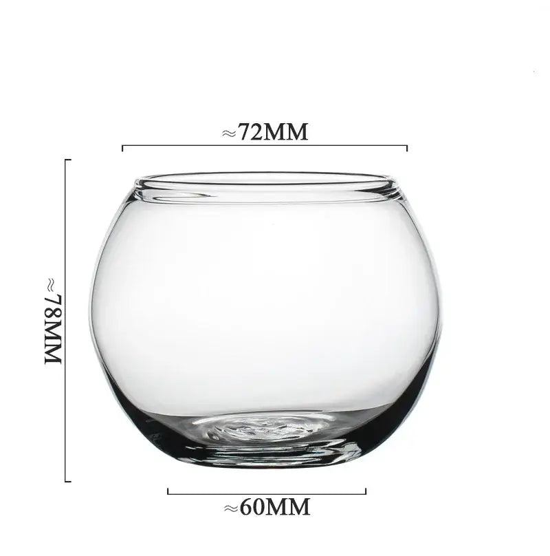 Clear glass fishbowl with rounded shape featured alongside a modern transparent glass coffee mug for kitchen and dining room