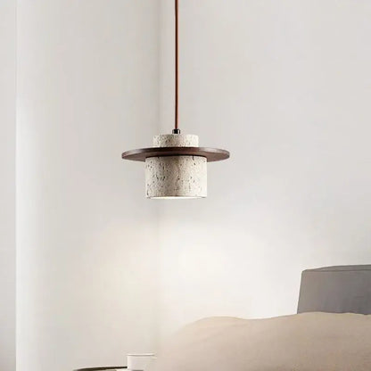 Minimalist pendant light with textured white concrete body dark wood accent ring copper-toned cord pendant bulb included