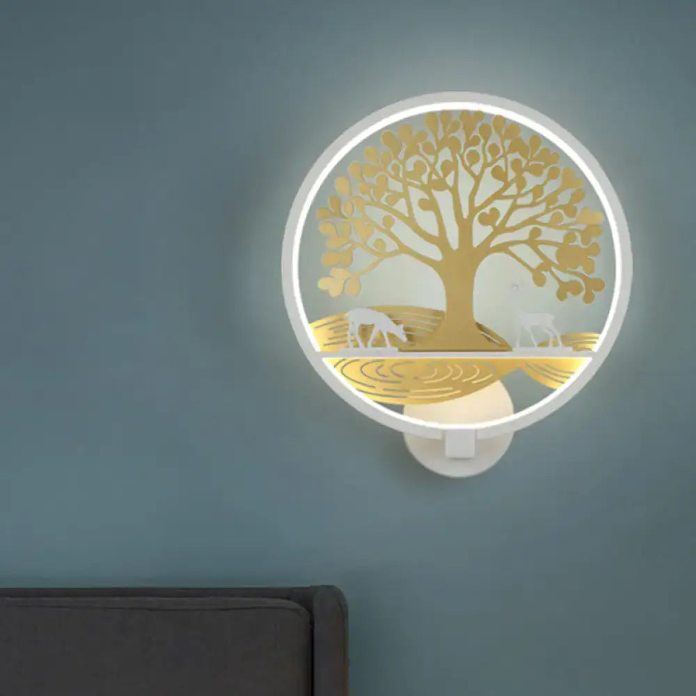 Modern wall lamp featuring a circular white frame with a golden tree of life and deer silhouettes for bedroom use