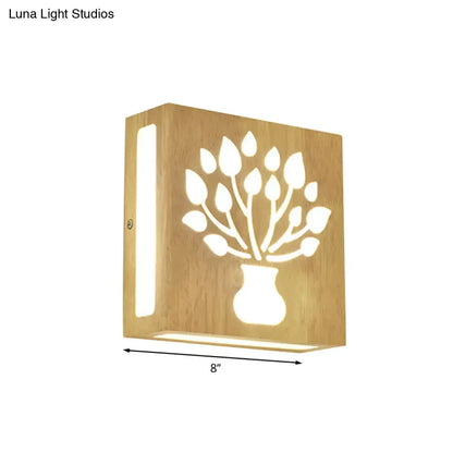 A warm-toned bamboo wall light with a tree silhouette cutout, direct wired electric for bedroom use and maximum bulb wattage