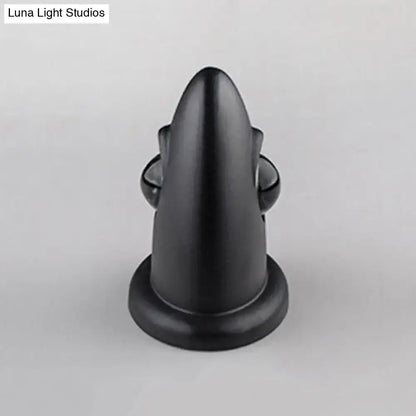 Black matte-finished door stop with sleek tapered design and rounded base for modern led bedroom wall sconce use