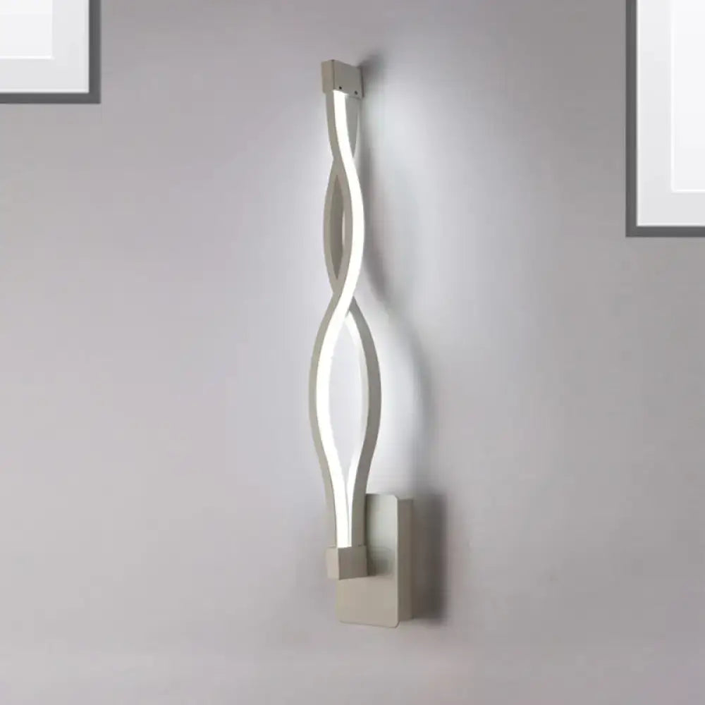 Modern silver-toned led wall sconce with sleek twisted design perfect for bedroom lighting and wall decor