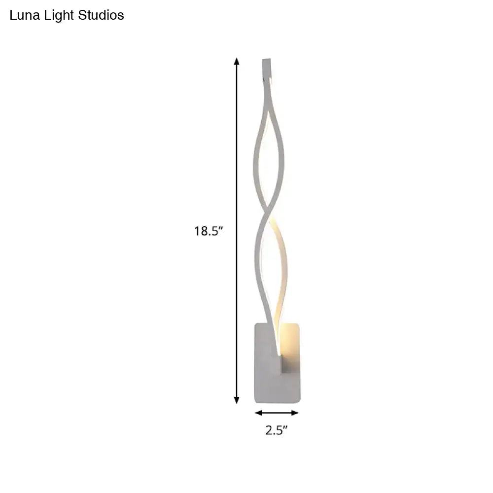 Modern twisted black and white led wall sconce with silver metal design providing warm ambient lighting for bedrooms