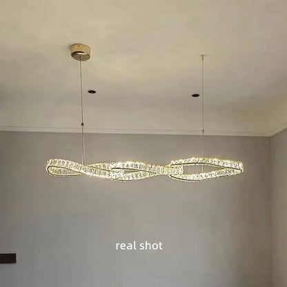 Modern twisted gold metal crystal pendant light featuring infinity-loop design with warm led for dining room decorbites gold metal crystal