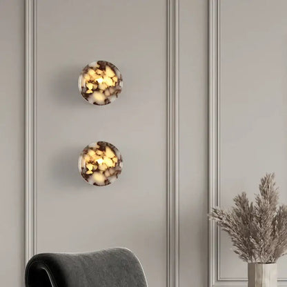 Two modern wabi sabi black and cream resin led wall lamps with marbled amber and dark brown tones for bedroom lighting