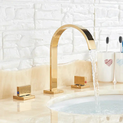 Modern waterfall dual handle gold basin faucet with sleek gold-toned arched design and flowing water stream decorbites dual handle