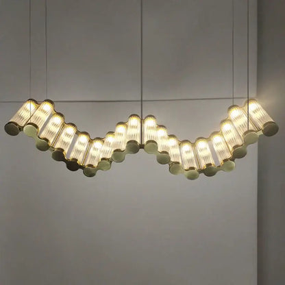 Curved modern decorbites golden chandelier with translucent ribbed glass tubes suspended in undulating pattern for living room