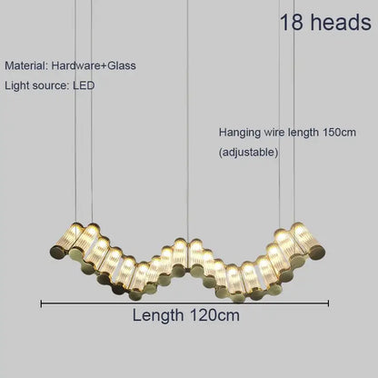 A modern wave decorbites golden chandelier with 18 golden glass and metal heads in a curved living room LED light design