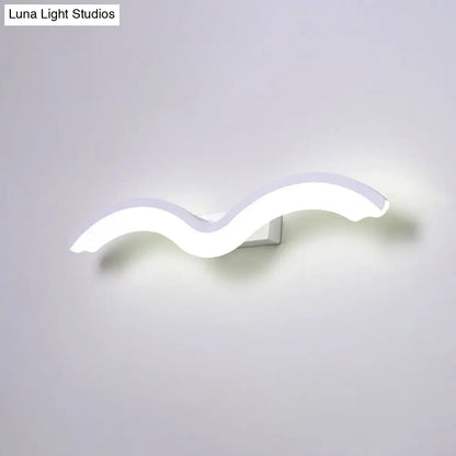 Modern wavelet black and white wall sconce with a sleek wavy design LED light for bathroom use