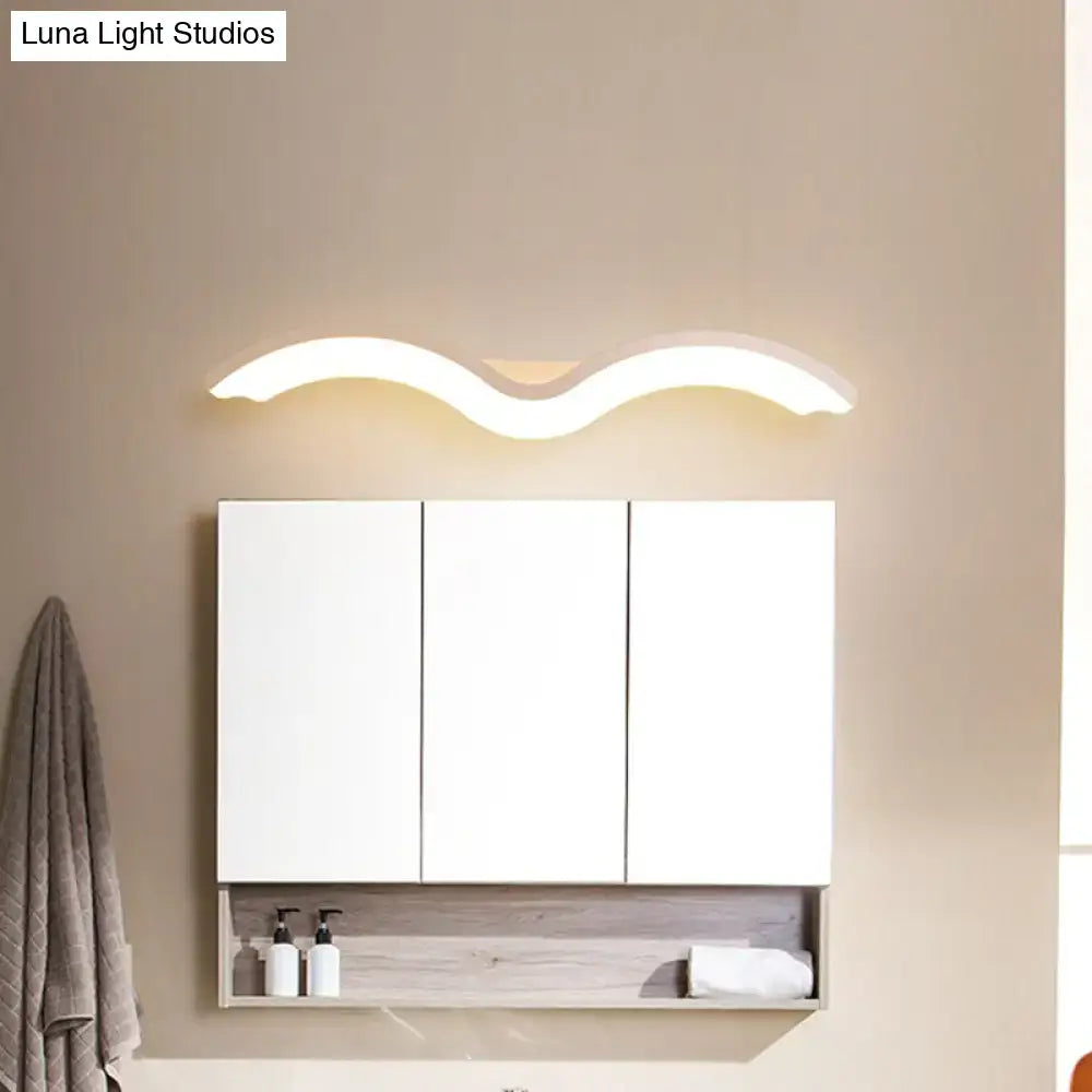 White three-door bathroom cabinet with a modern wavelet black and white wall sconce led light fixture above it