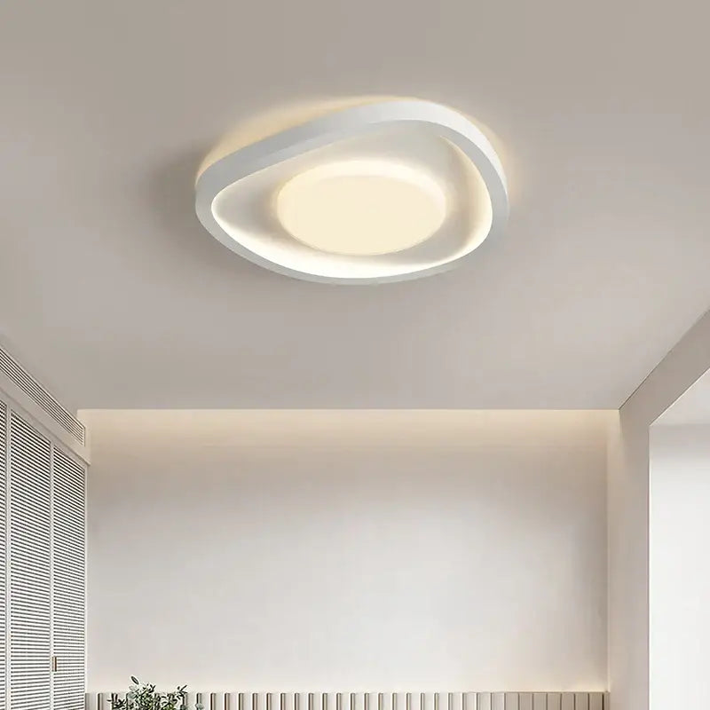 Modern wavy cream style led ceiling lamp with oval design and soft ambient glow for living room decorbites cream style