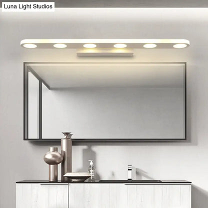 Modern rectangular bathroom mirror with a sleek black frame illuminated by a white 3-light vanity wall light with warm white light