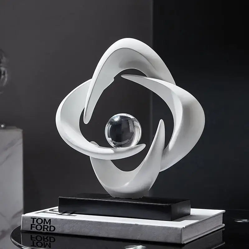 Modern white abstract resin sculpture figurine with flowing curves encircling glass sphere on black base decorbites abstract resin decor