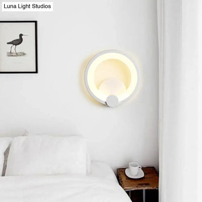 Modern white acrylic sconce light with circular design and warm ambient lighting for bedroom wall installation