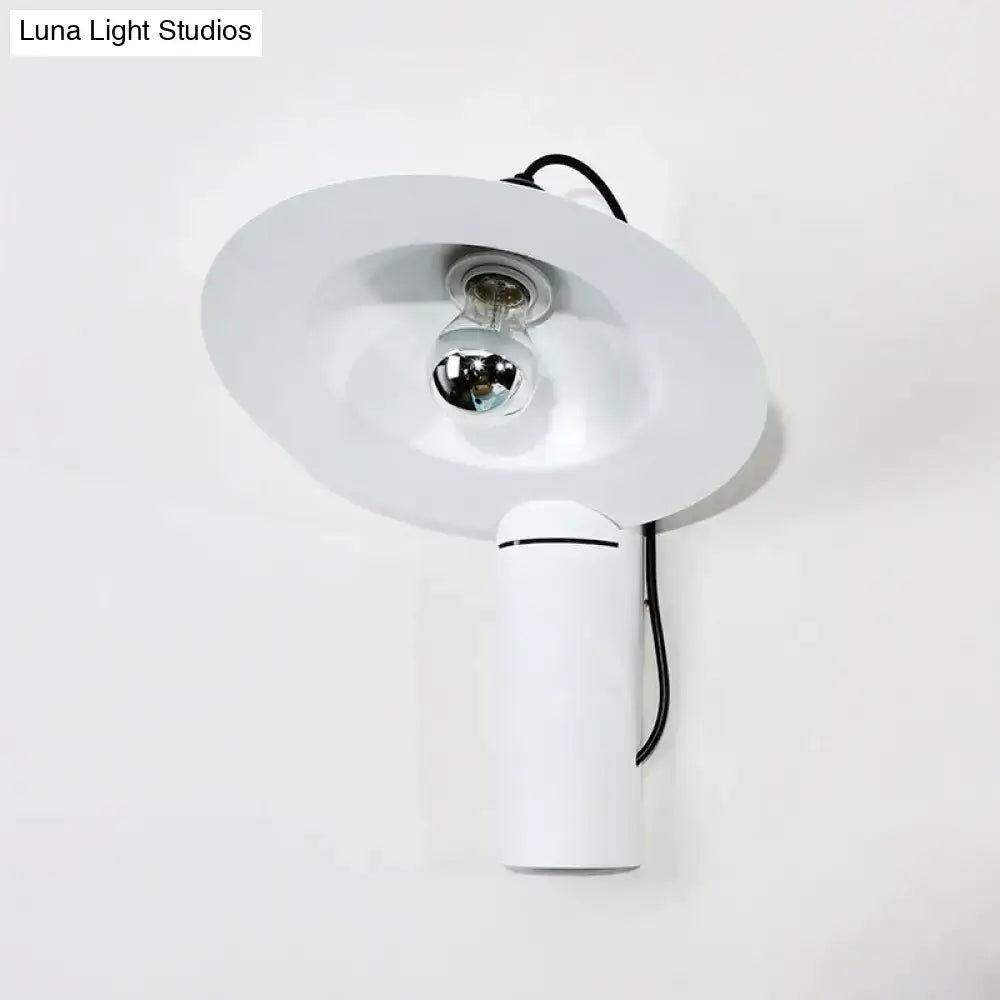 Modern white adjustable wall sconce with a sleek cylindrical base and shallow bowl shade for bedroom reading lamp
