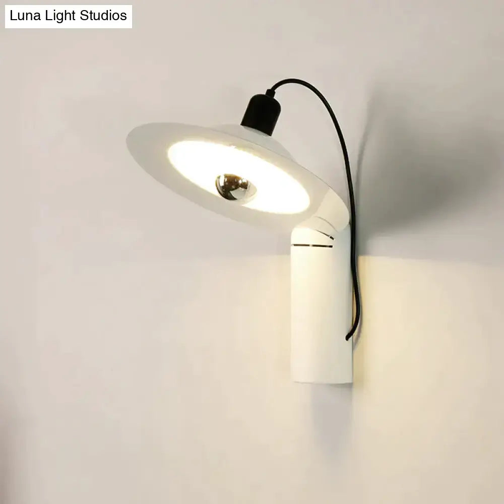 Modern white adjustable wall sconce with sleek design and circular shade for bedroom reading use mounted on wall