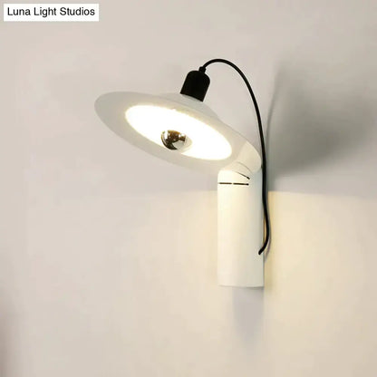 Modern white adjustable wall sconce with sleek design and circular shade for bedroom reading use mounted on wall