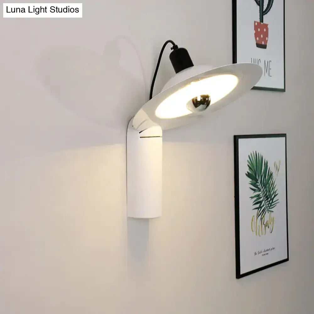 Modern white adjustable wall sconce with sleek curved shade and visible bulb ideal for bedroom reading lighting