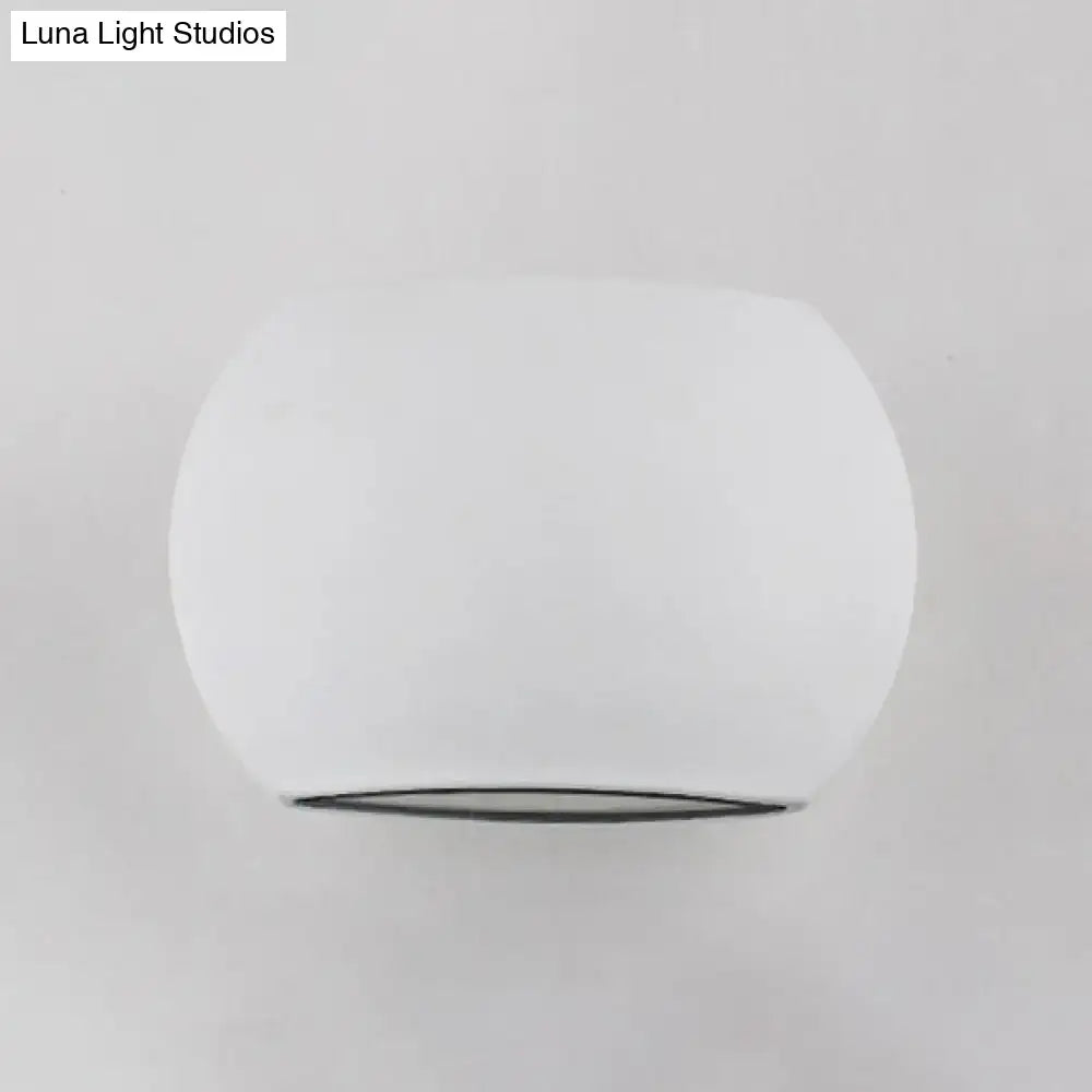 Modern white and black oval led wall lamp with direct wired electric connection and a smooth rounded glass dome