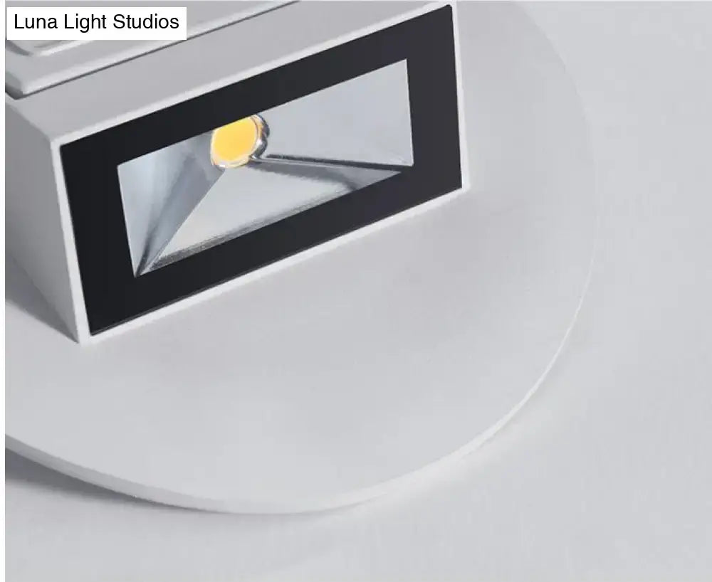 Modern white and black wall sconce bedroom led spotlight with rectangular design and visible yellowish light source