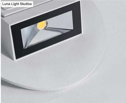 Modern white and black wall sconce bedroom led spotlight with rectangular design and visible yellowish light source