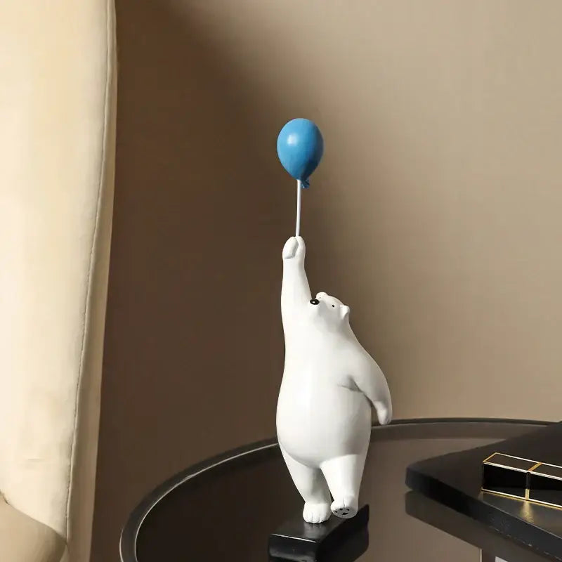 Modern white ceramic polar bear figurine holding a blue balloon as decorbites flying bear balloon decor for living room