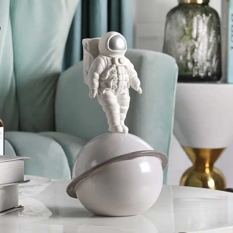 Modern white and gold astronaut phone holder figurine standing atop a glossy white planet with gray ring decorbites astronaut phone decor