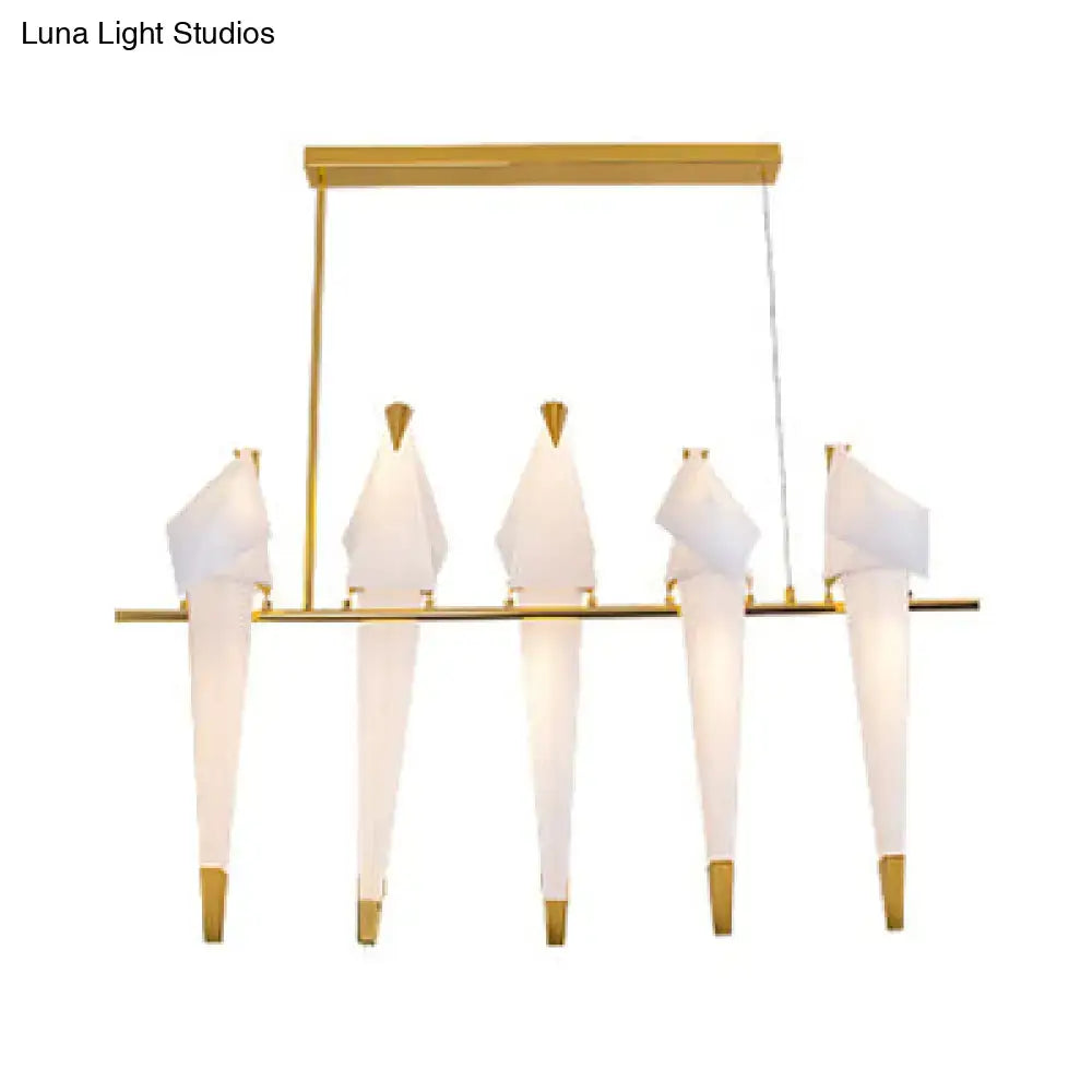 Gold-toned decorbites™ modern bird shaped island pendant light with five white paper-like bird fixtures hanging