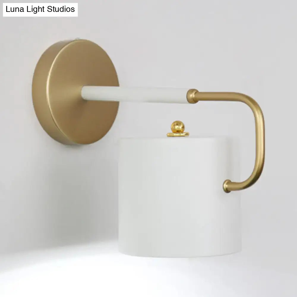 Modern white marble toilet paper holder with gold-toned accents complements cylinder wall lamp sconce light fixture design