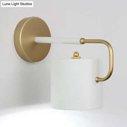 Modern white marble toilet paper holder with gold-toned accents complements cylinder wall lamp sconce light fixture design