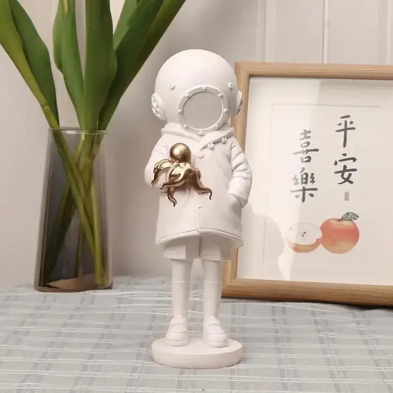 Modern white and gold deepsea diver sculpture holding a golden octopus for living room decor