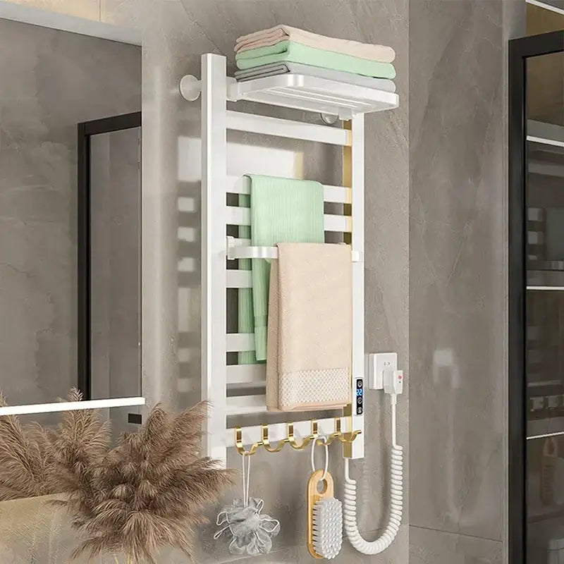 Modern white and gold electric towel radiator with towel radiator warmer hooks and top shelf holding folded towels