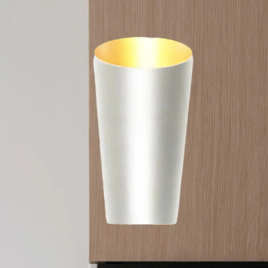 A modern led bedside sconce wall light with a sleek white cylindrical body and warm gold interior lining