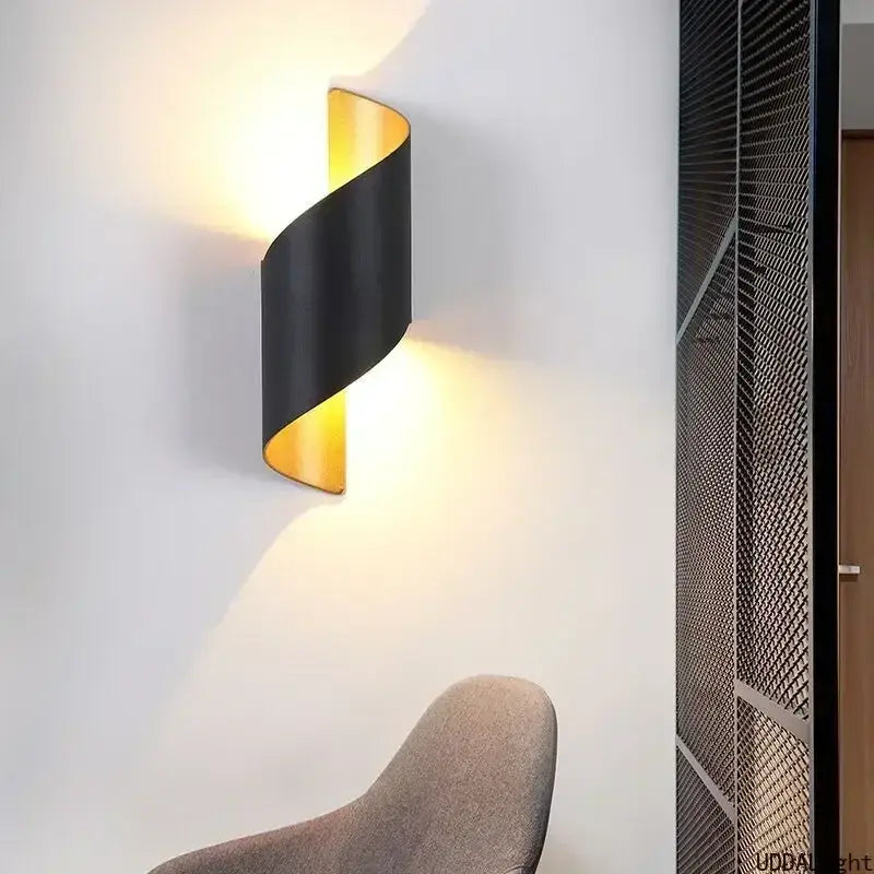 Black and gold twisted outdoor wall lamp with sleek modern design for patio use as a spiral outdoor wall sconce