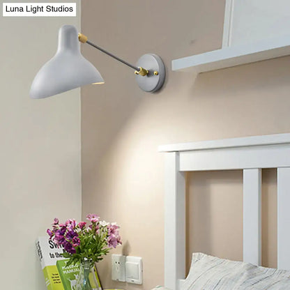 Modern white and gold wall mounted lamp with slender metallic arm and adjustable light for living room use