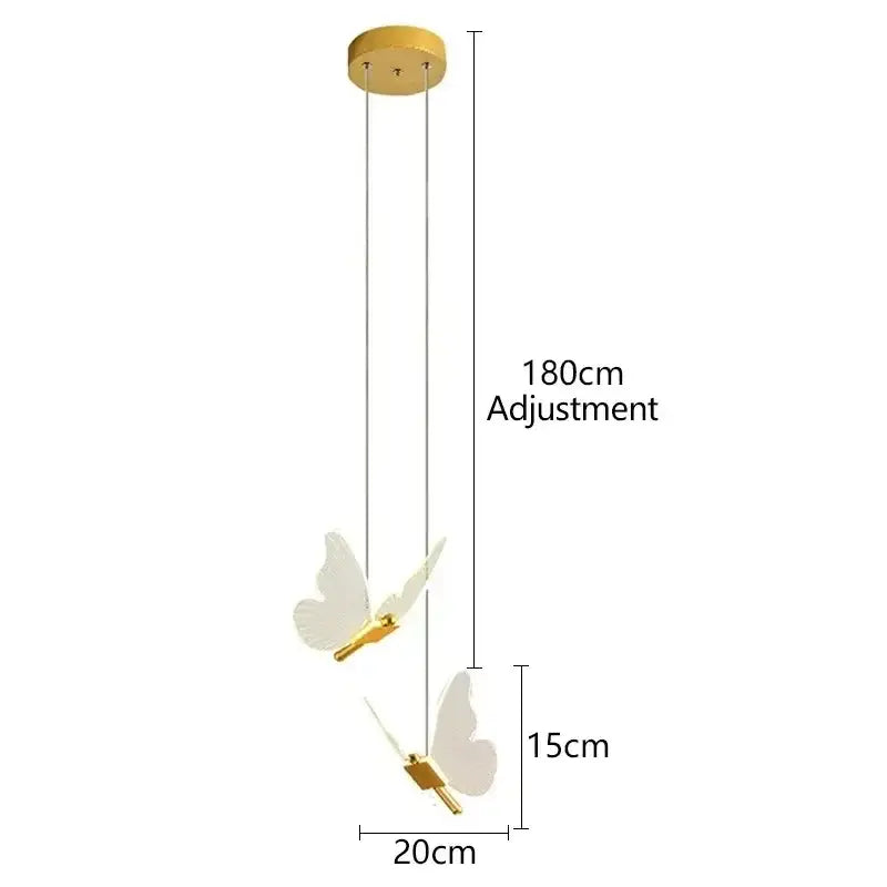 Modern 3-light pendant light with warm gold finish and white butterfly-shaped translucent fixtures for bedroom use