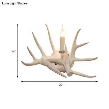 Modern white antler resin shade wall sconce featuring an intricately carved design with a candle-style bulb center