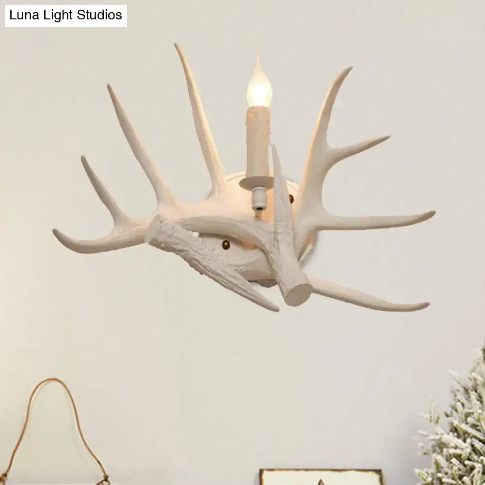 Modern white antler resin shade wall sconce featuring a white ceramic deer antler design with candle-style bulb for living room lighting