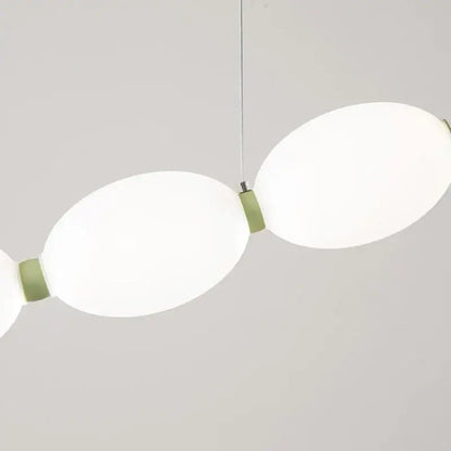 Modern white bead nordic chandelier with two oval frosted glass shades and matte sage green metal joints for dining room