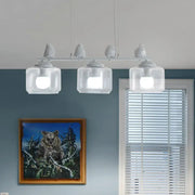 White bird-themed pendant island lighting fixture with clear glass shades and modern design for dining room use