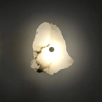 Modern white and black alabaster wall lamp with irregular glowing stone sconce and central circular cutout by decorbites brass