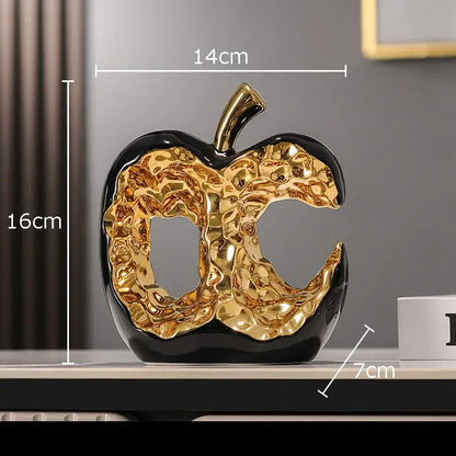 Shiny gold and black ceramic apple sculpture with glossy textured finish for modern desk decoration or living room decor