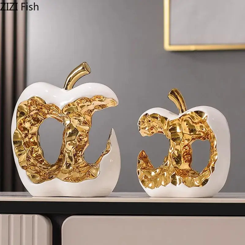 Modern white ceramic apple sculpture with gold leaf and metallic stem perfect for desk decoration or living room decor