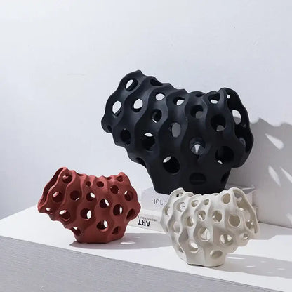 Modern white and black coral geometric resin sculpture set featuring porous ceramic designs in black terracotta and off-white