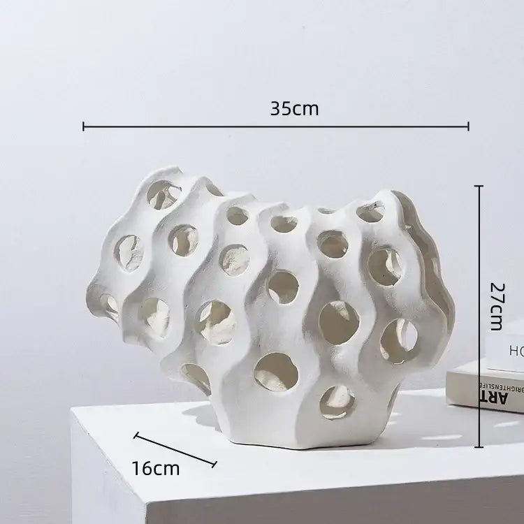 Modern white and black coral geometric resin sculpture with porous organic design and multiple circular holes for living room decor