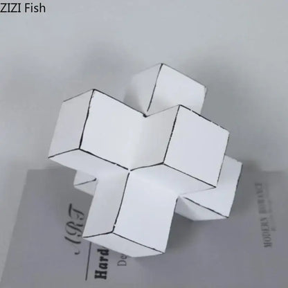 Modern white and black cube block sculpture made of folded paper with black outline detailing for living room art