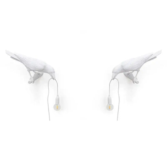 Modern white ceramic wall lamp by decorbites designer bird featuring black crow shape holding small bulbs for bedroom light decor