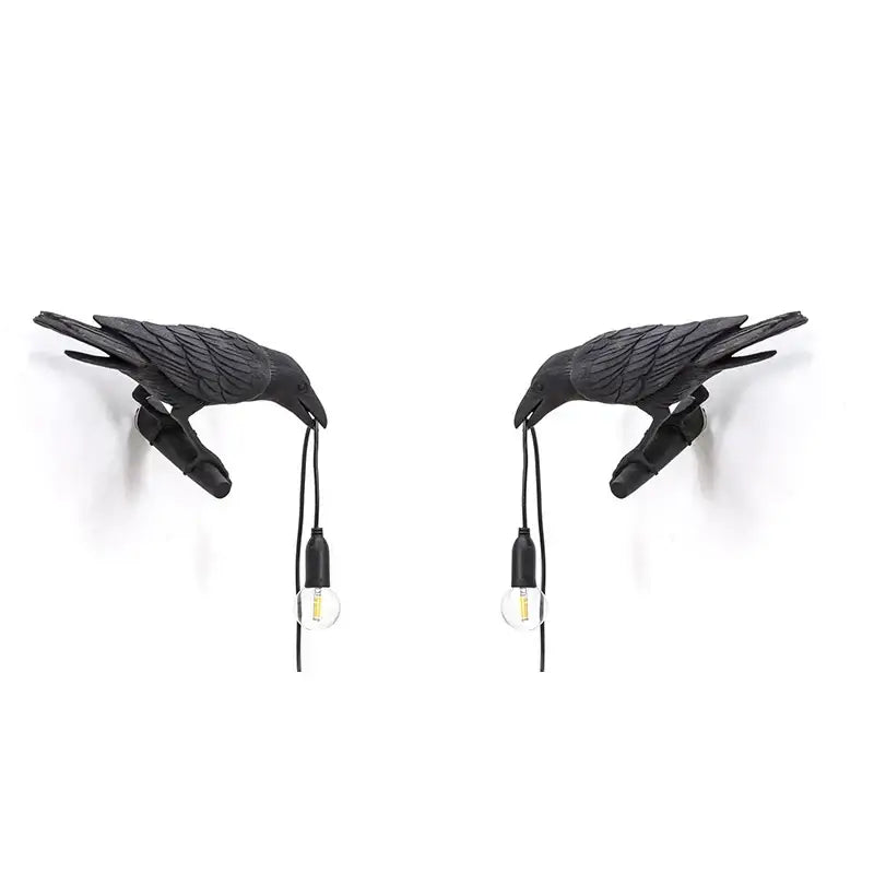 Black crow-shaped wall lamp with detailed feathers and clear bulb sockets by decorbites designer bird wall decor