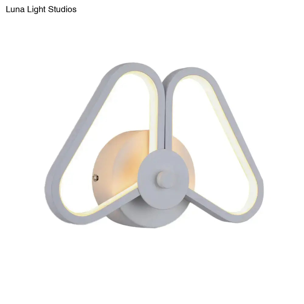 Modern white black led triangle wall sconce with sleek symmetrical design and warm ambient lighting for living room use